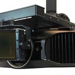 The CineVista seen here mounted in front of a projector.  The mounting requires a fair amount of precision work and is permanent ie it does not slide on or off.